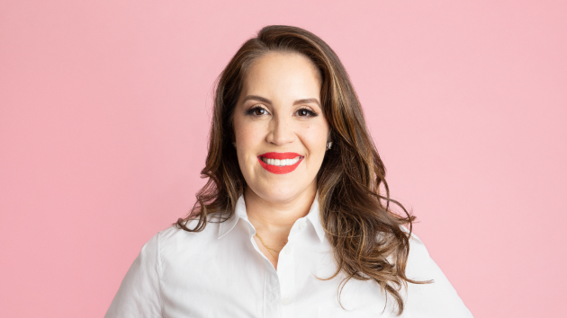 Portrait of Cactus Foods owner Diana Gonzalez smiling and holding a package of Cactus snacks