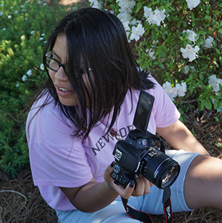 Emily Hernandez-Mendez stands in front of flowers